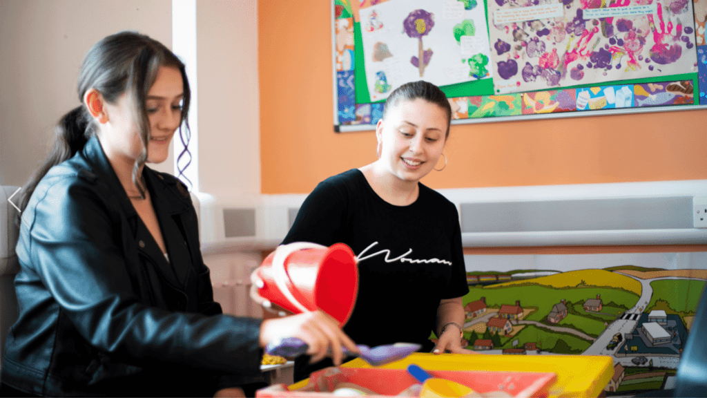 Adults using childrens learning materials.