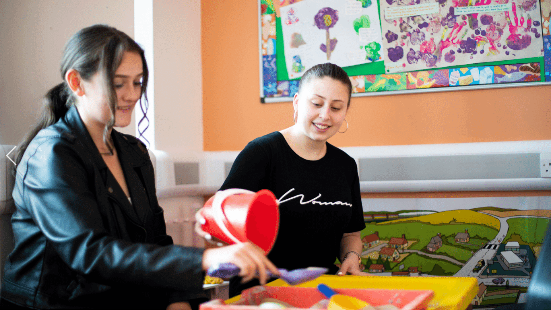 Adults using childrens learning materials.