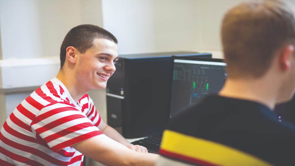 Male students sitting at computers.