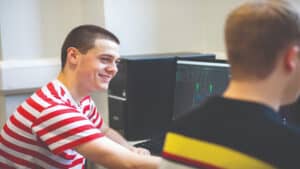 Male students sitting at computers.