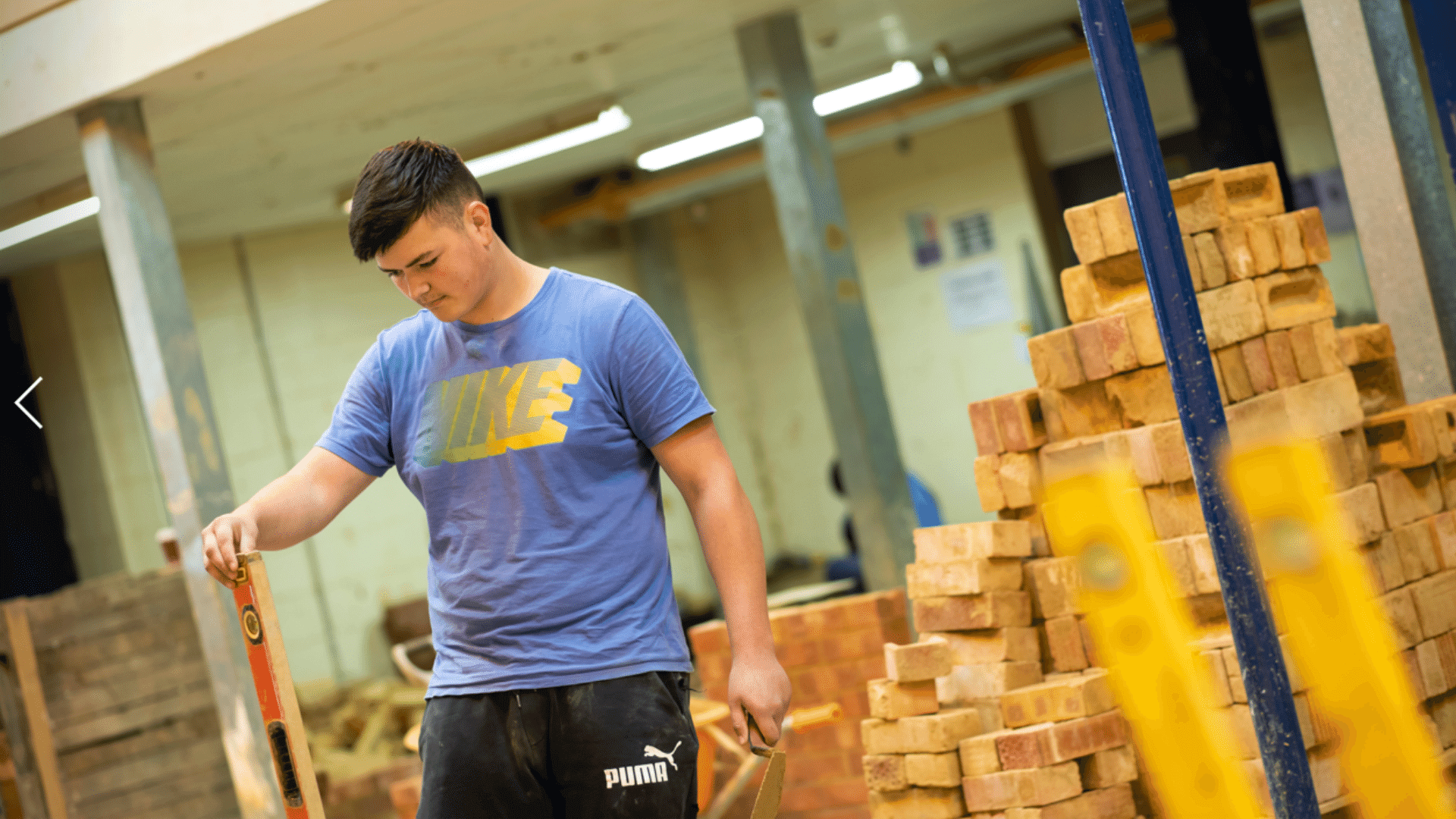 Adult learner using construction materials.