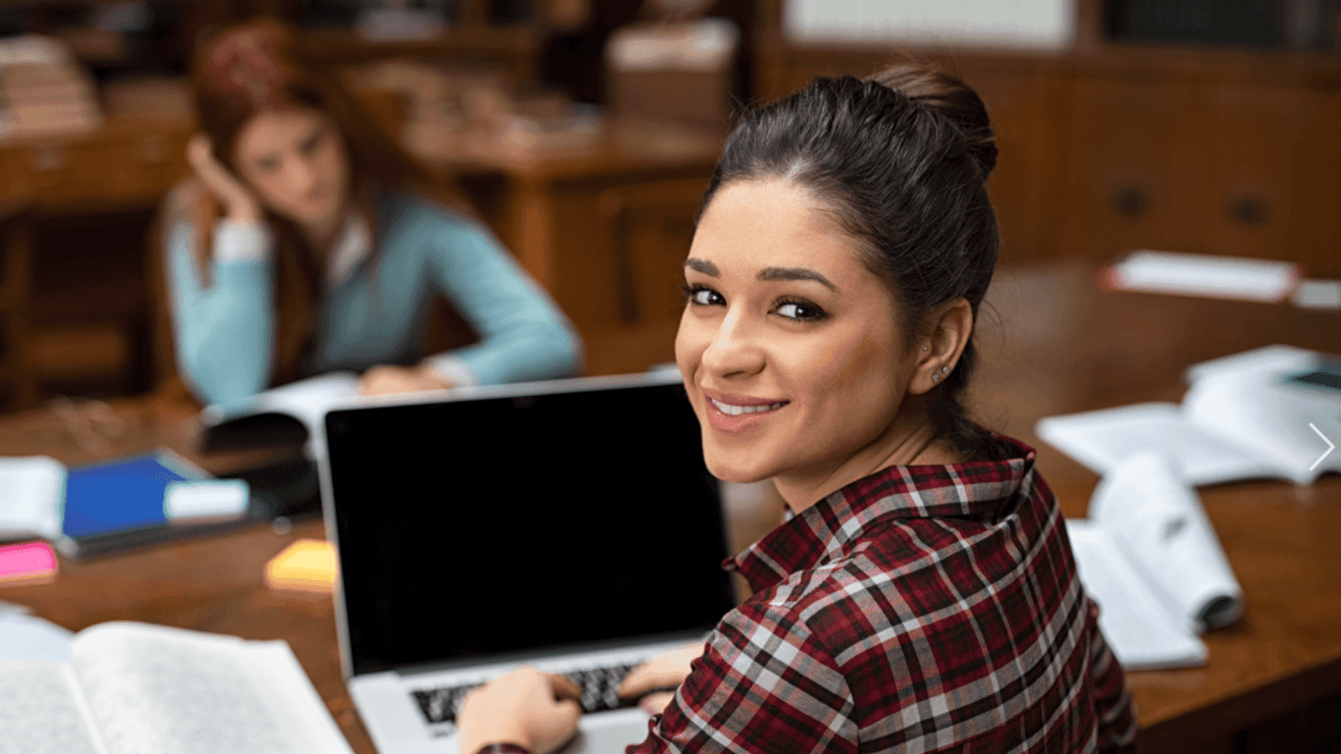Student looking happy at laptop.