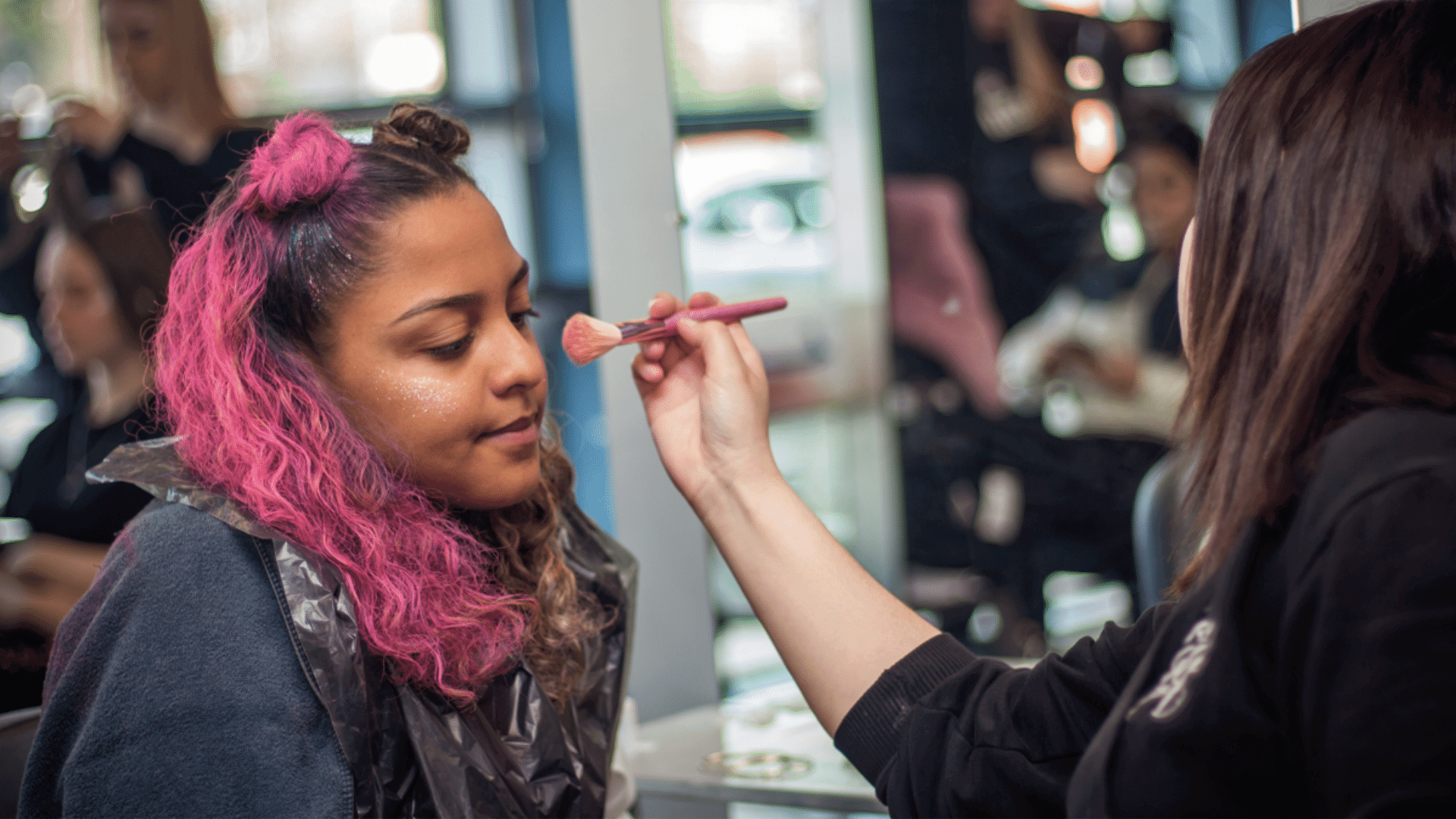 Learner applying makeup.