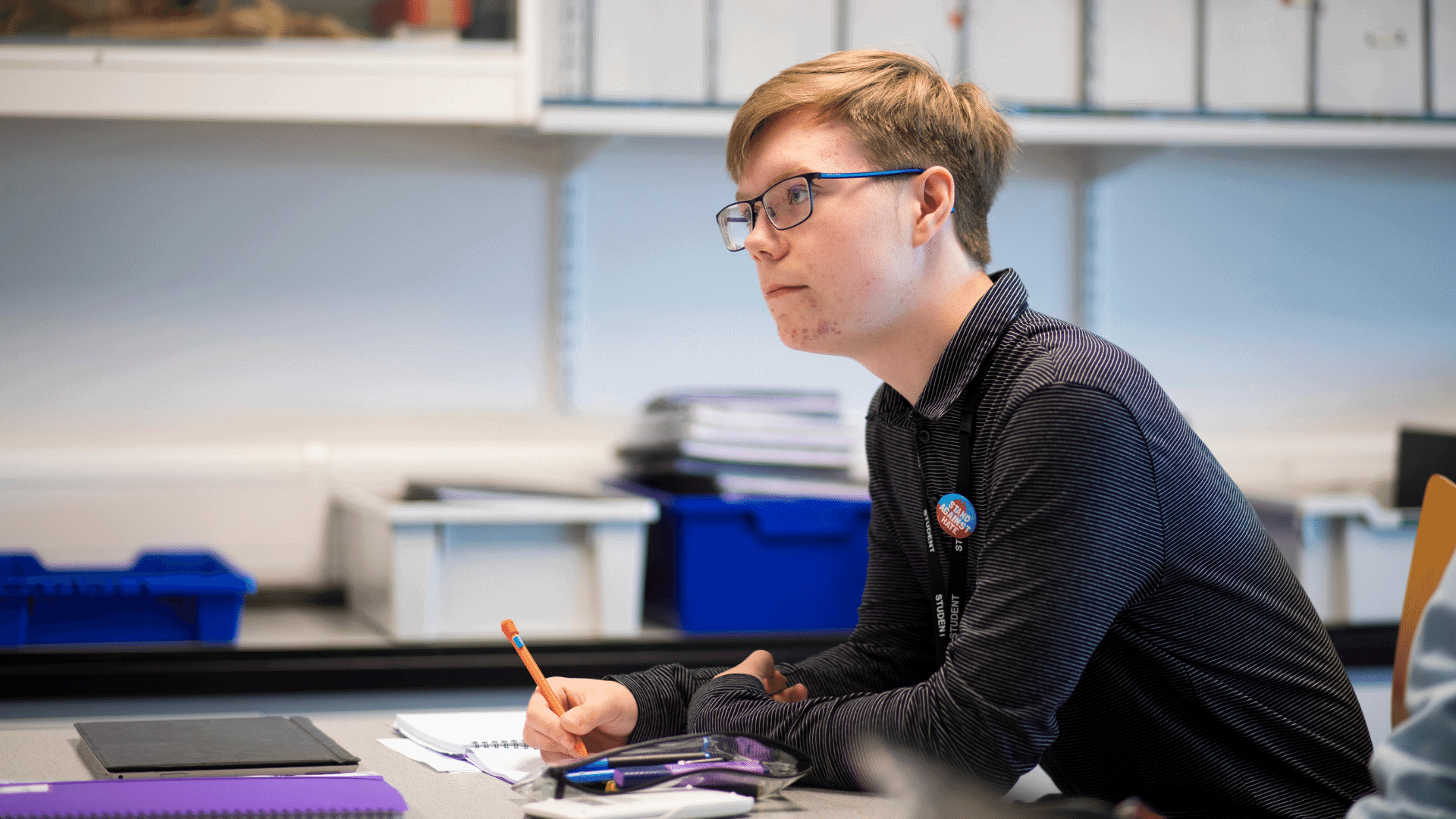 Student sitting at desk taking notes.