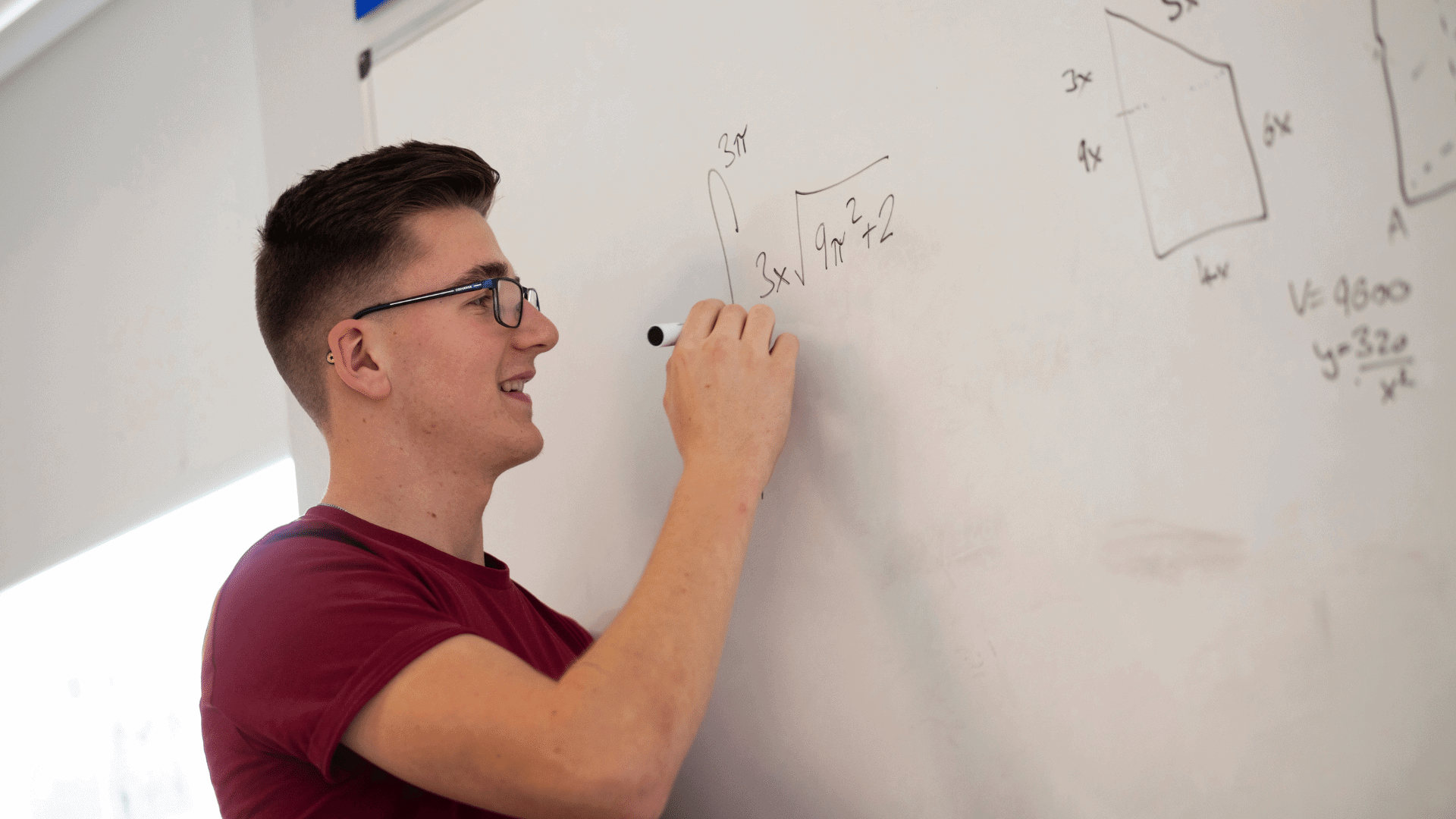 Student at whiteboard.