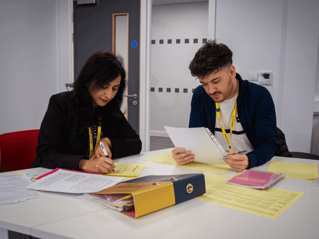 HE Student studying with support from staff