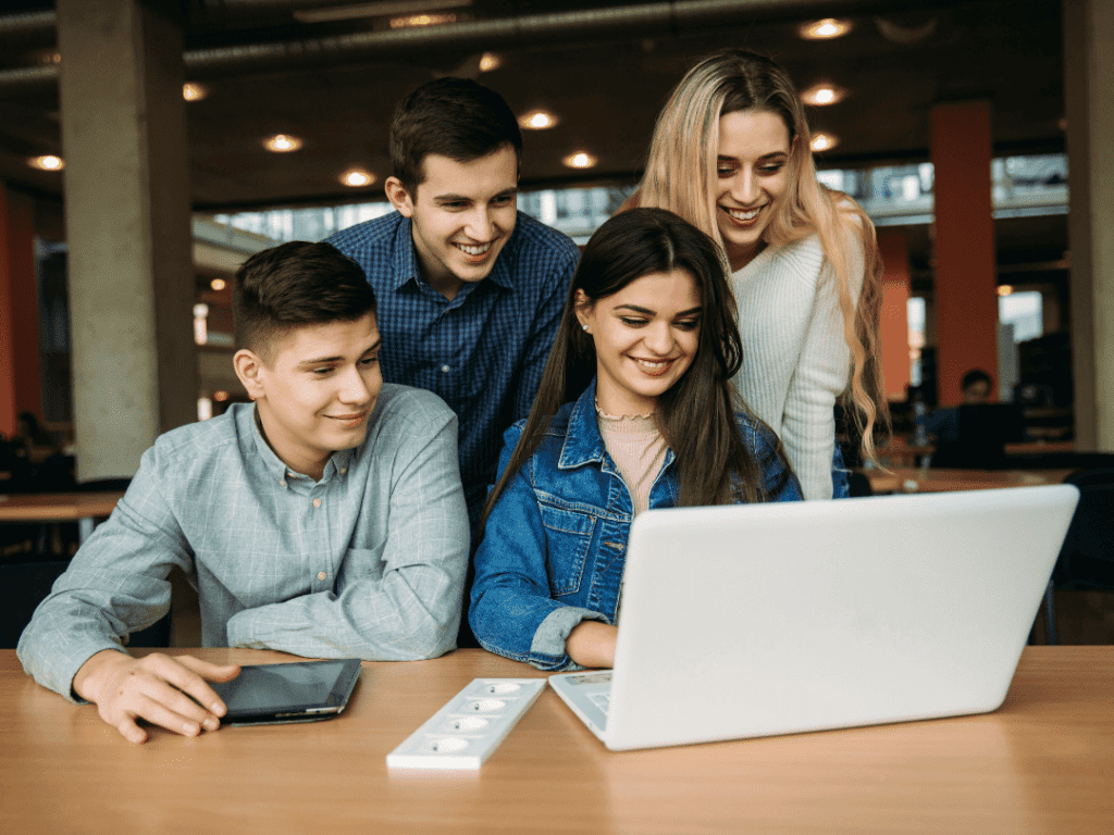 Students gather round laptop