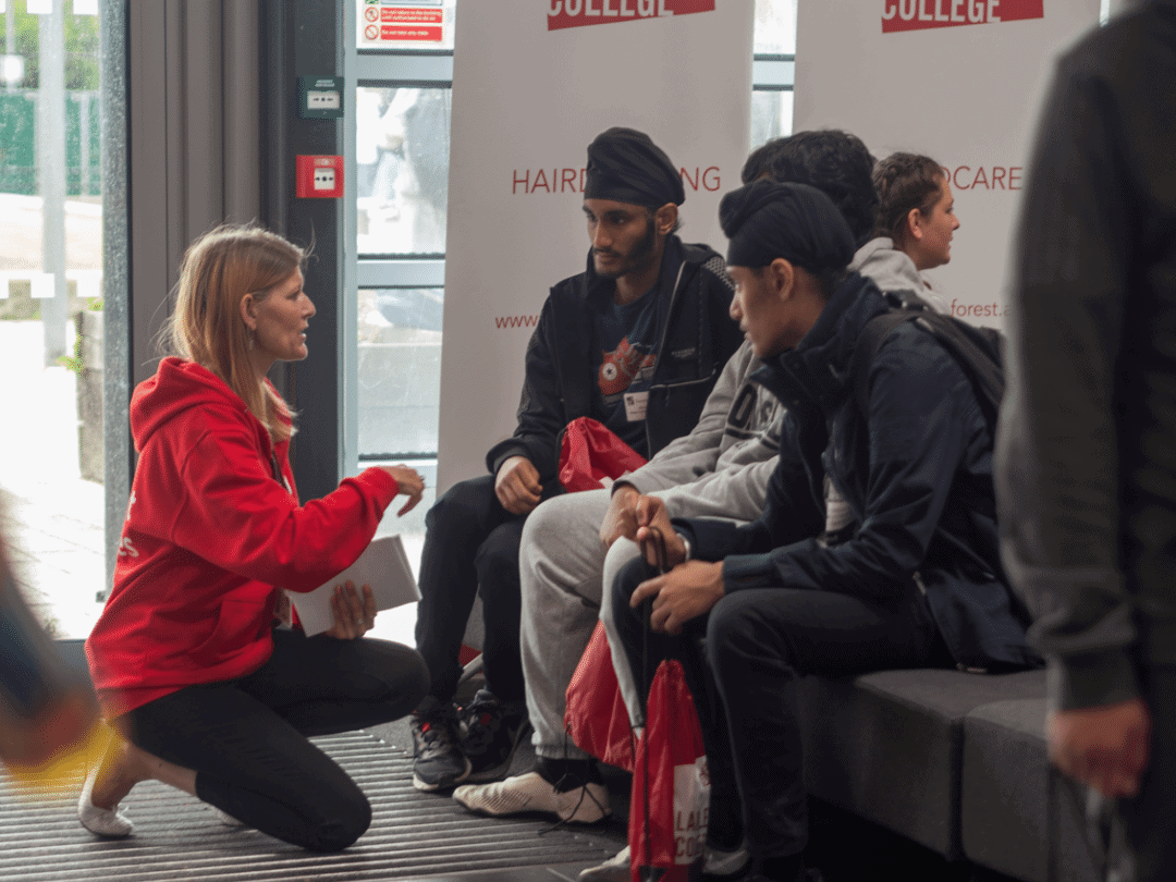 Student services staff member talking to students