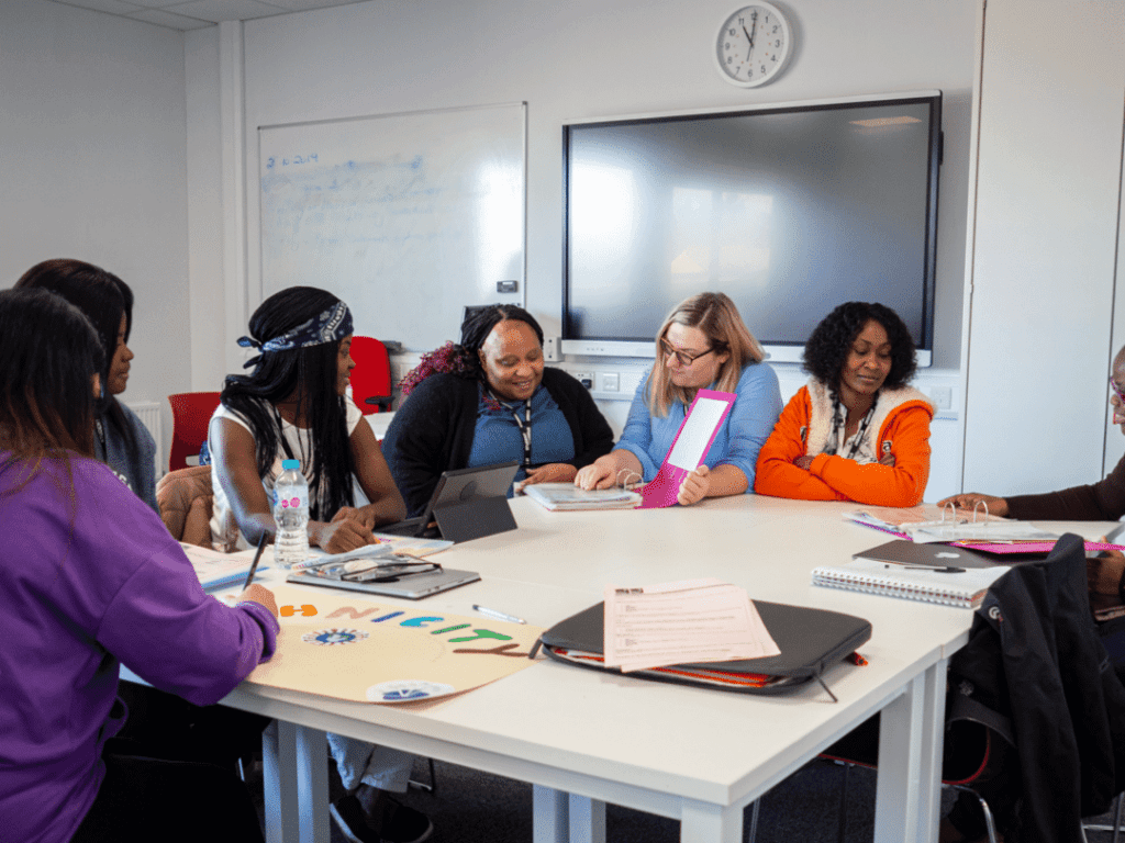 Students meeting at table to discuss work