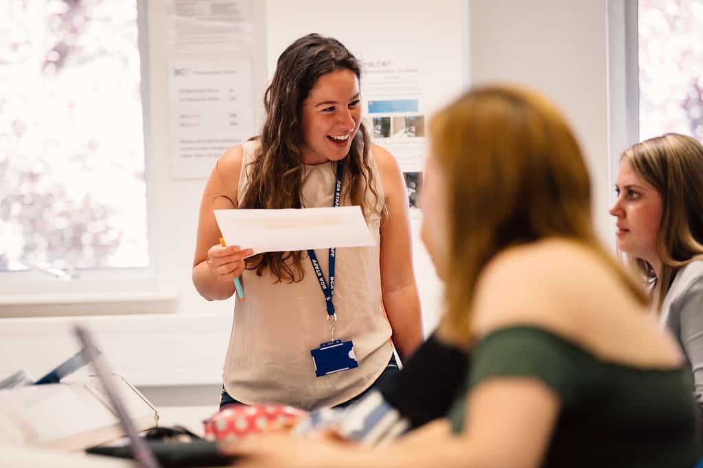Teacher smiling at class
