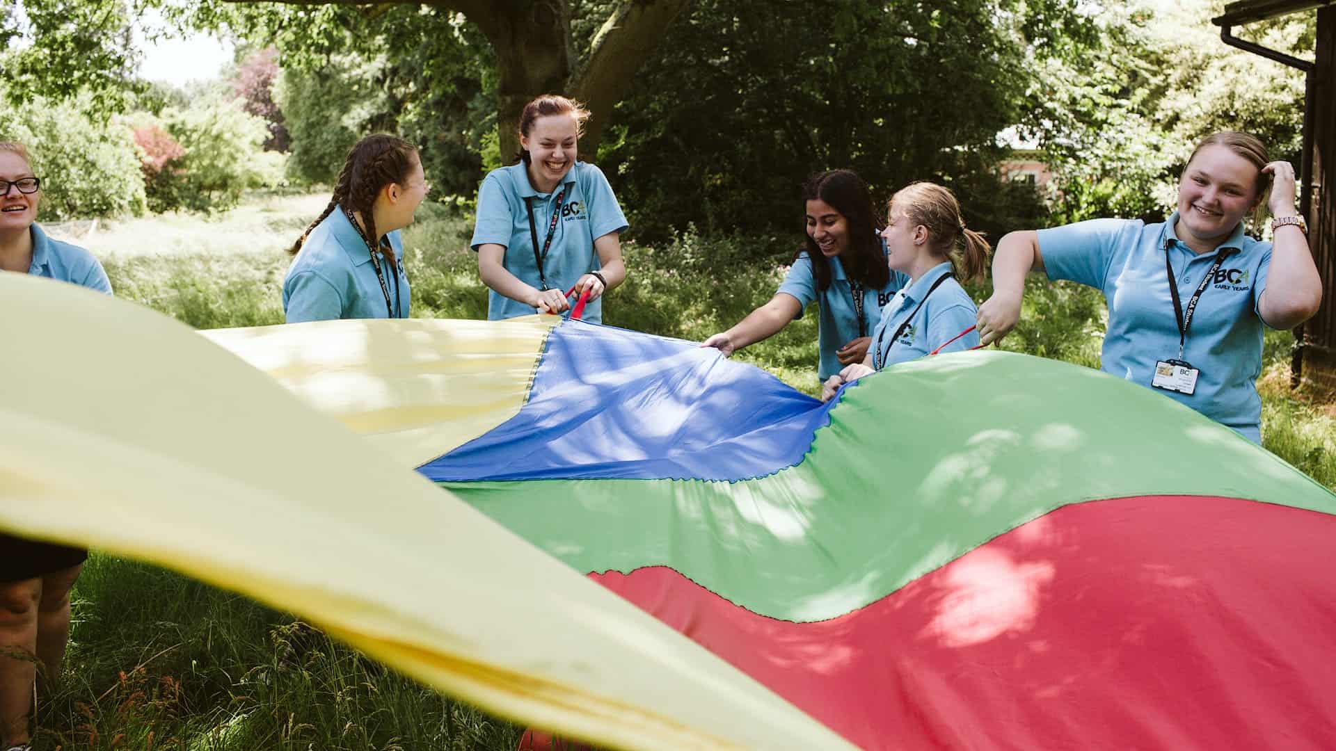 students with rainbow parachute