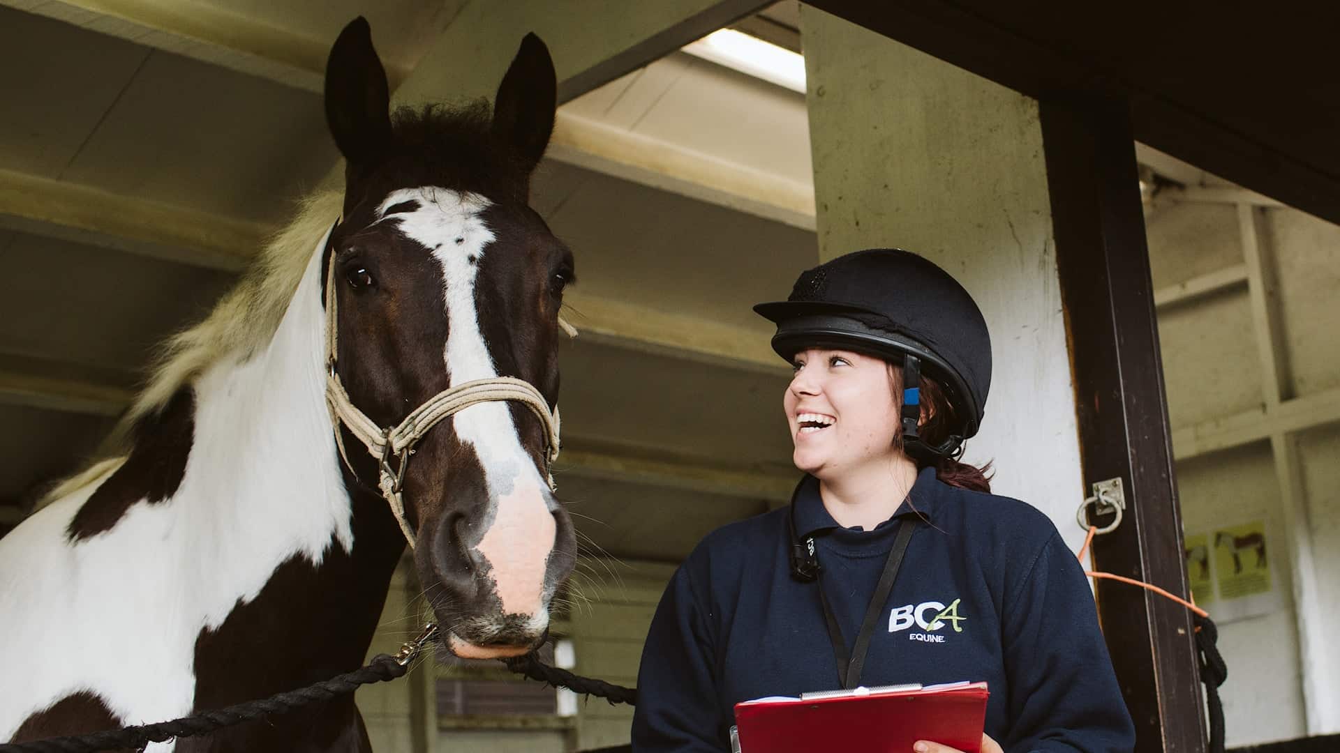 student posing with horse