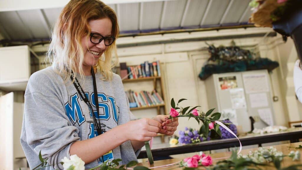 Student arranging flowers