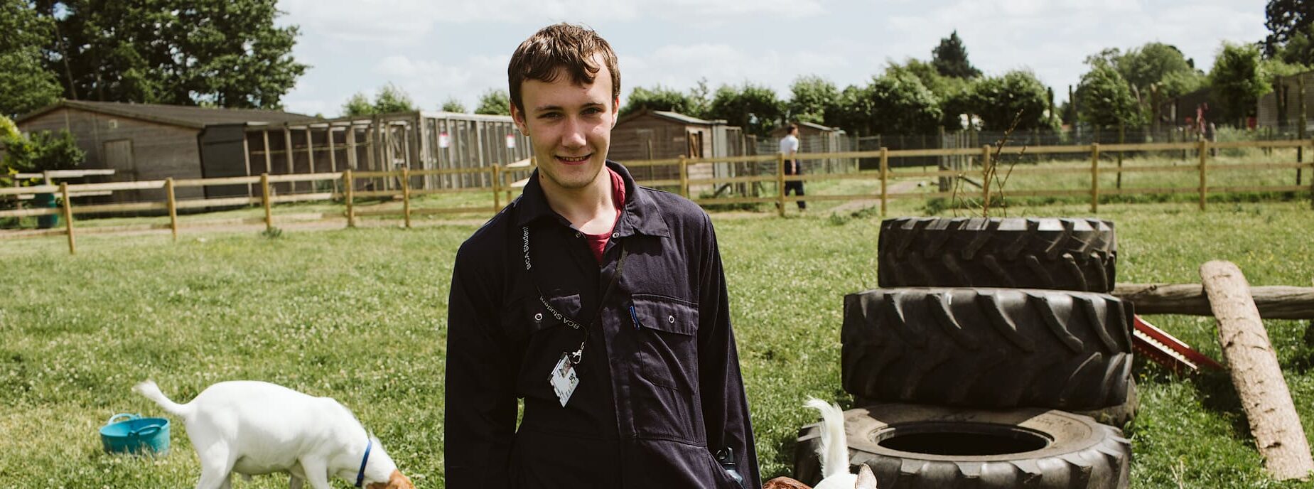 Student posing with baby goats