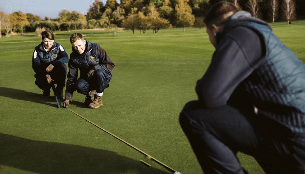 Students measuring on golf course