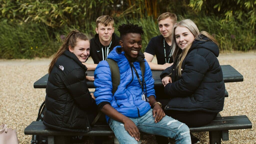 Students sitting and looking at camera