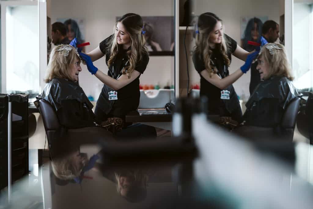 Students in salon cutting hair