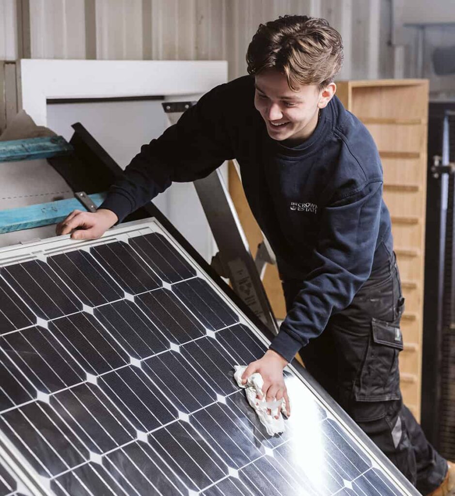 student polishing solar panel