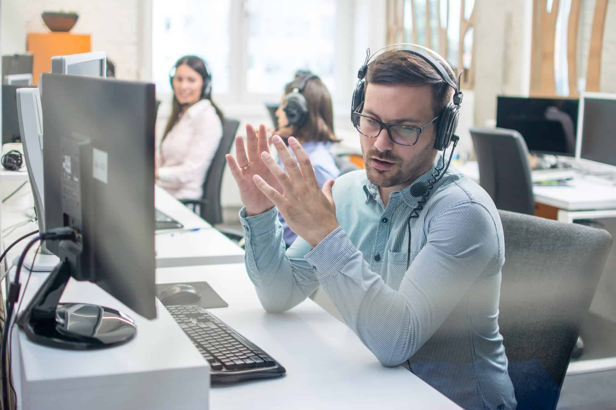 man working in IT support at a desk