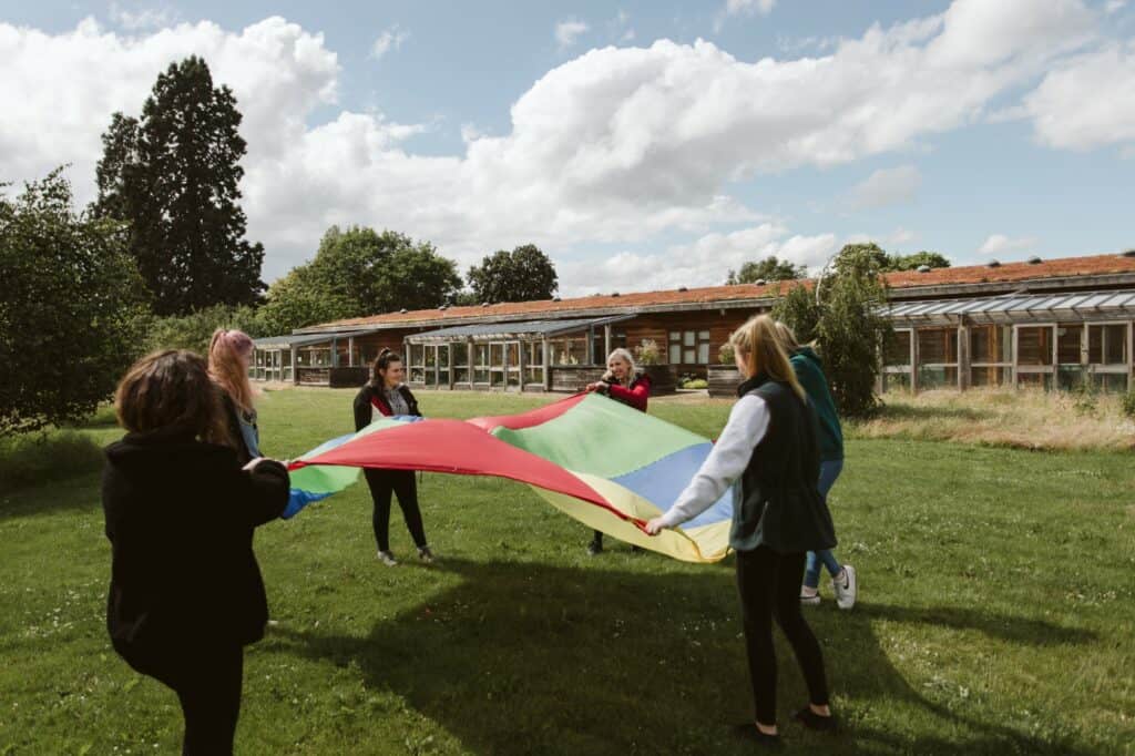 early years students with parachute
