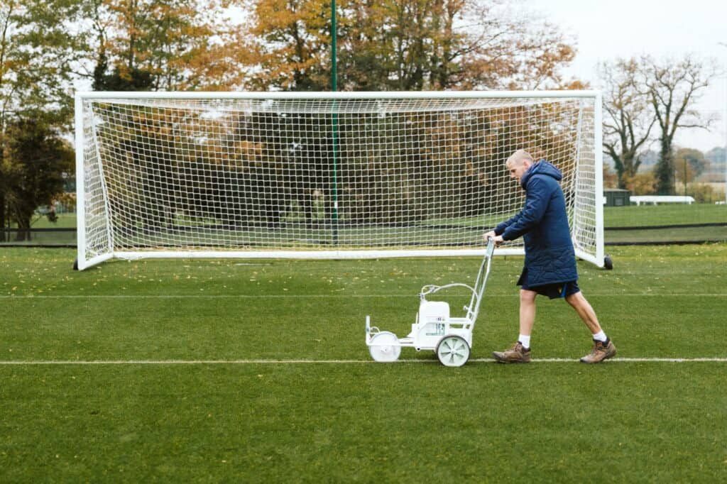 sports turf student mowing the lawn