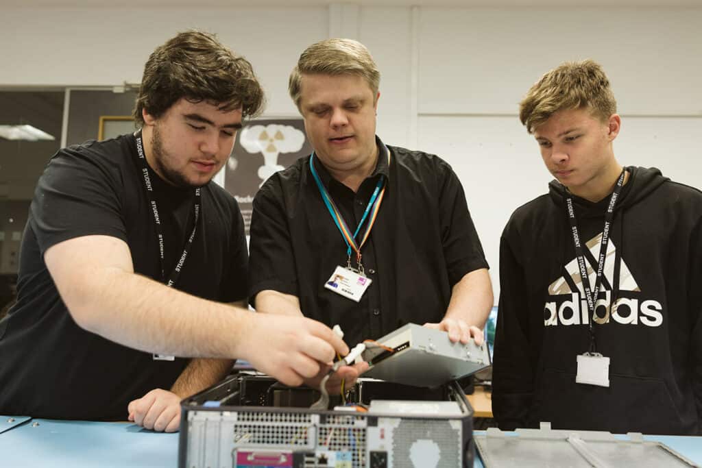 computing & IT student and teacher working on a computer