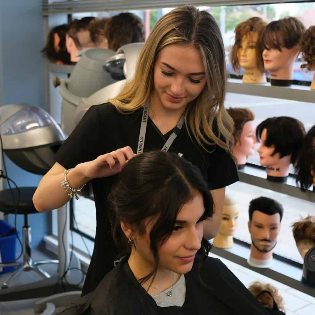 Hair student putting a model's hair up