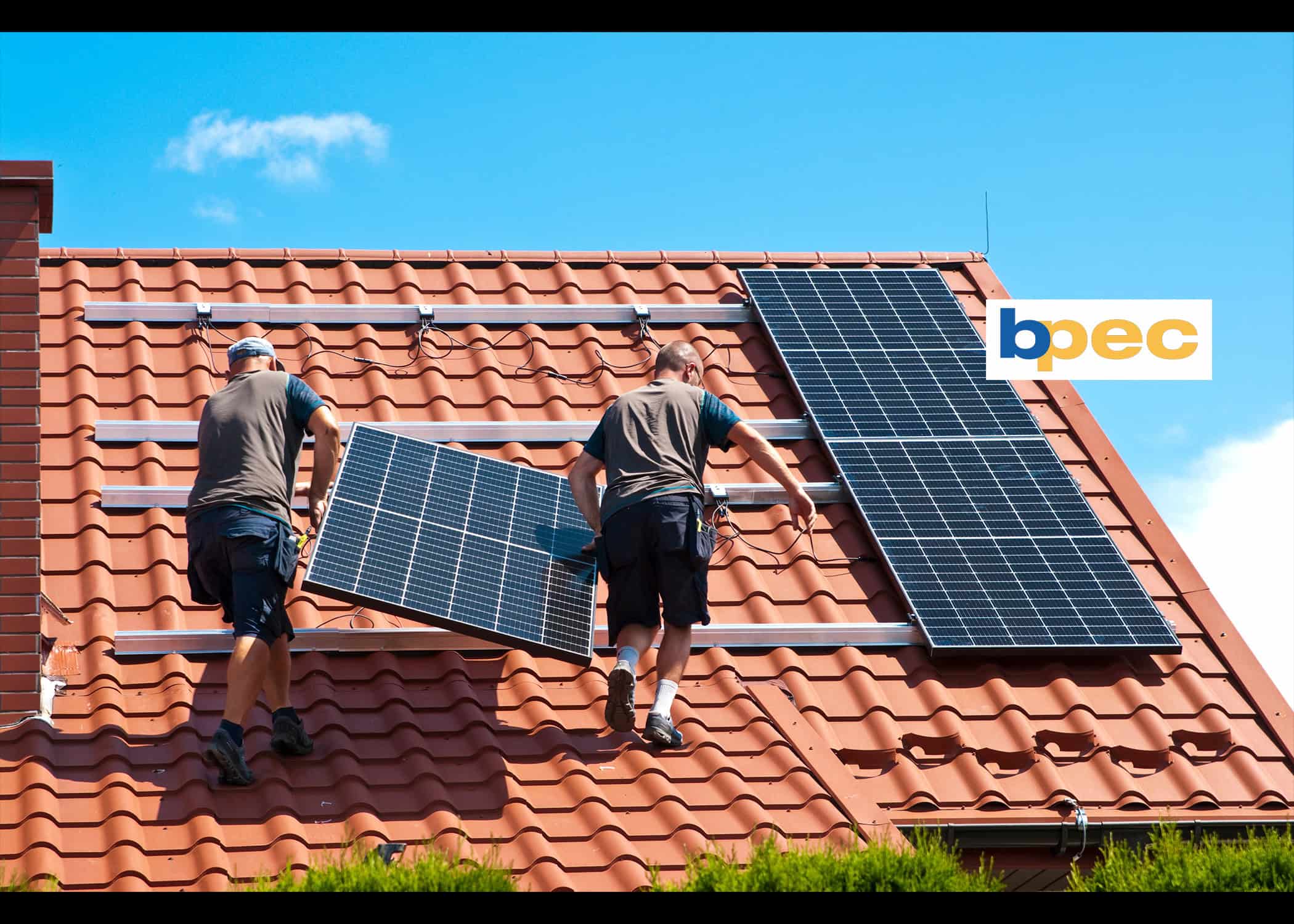 Men putting solar panels on roof