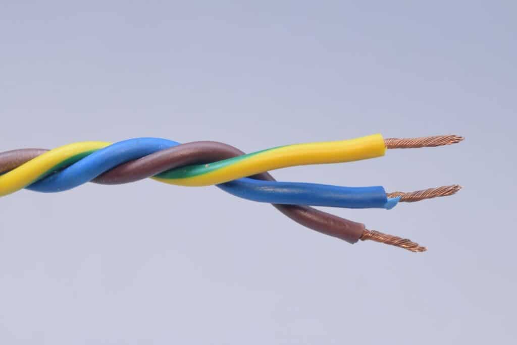 Three multicoloured electrical wires intertwined