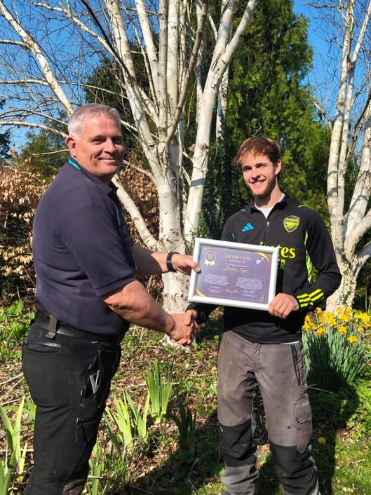 The winner receiving his certificate from the BCA skills coach