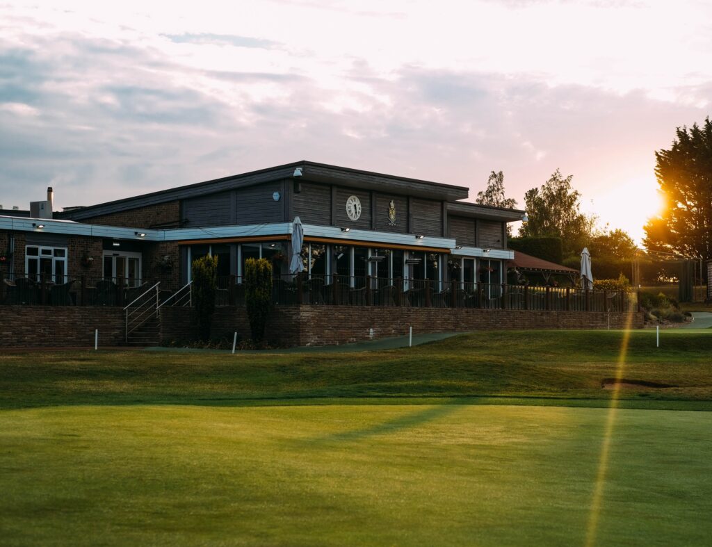 The Bury St Edmunds Golf Club pavilion in front of the rising sun