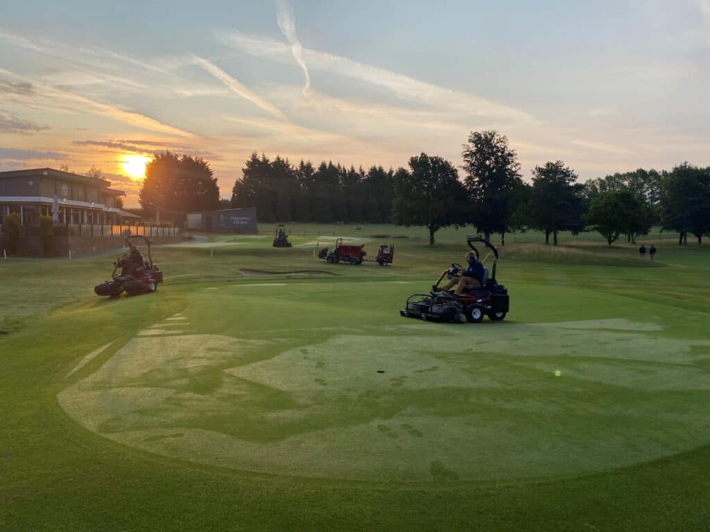 The grounds team at work early in the morning at Bury St Edmunds Golf Club as the sun rises