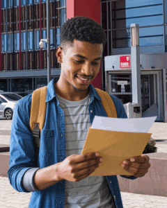A student holding their results outside Slough & Langley College