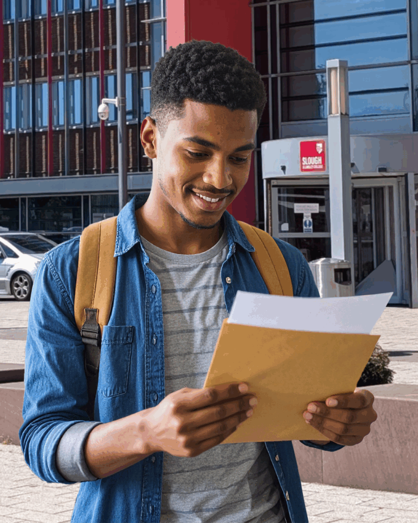 A student holding their results outside Slough & Langley College