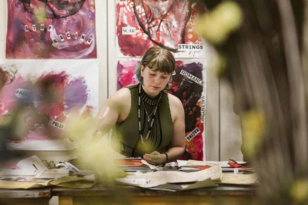 A student sat painting