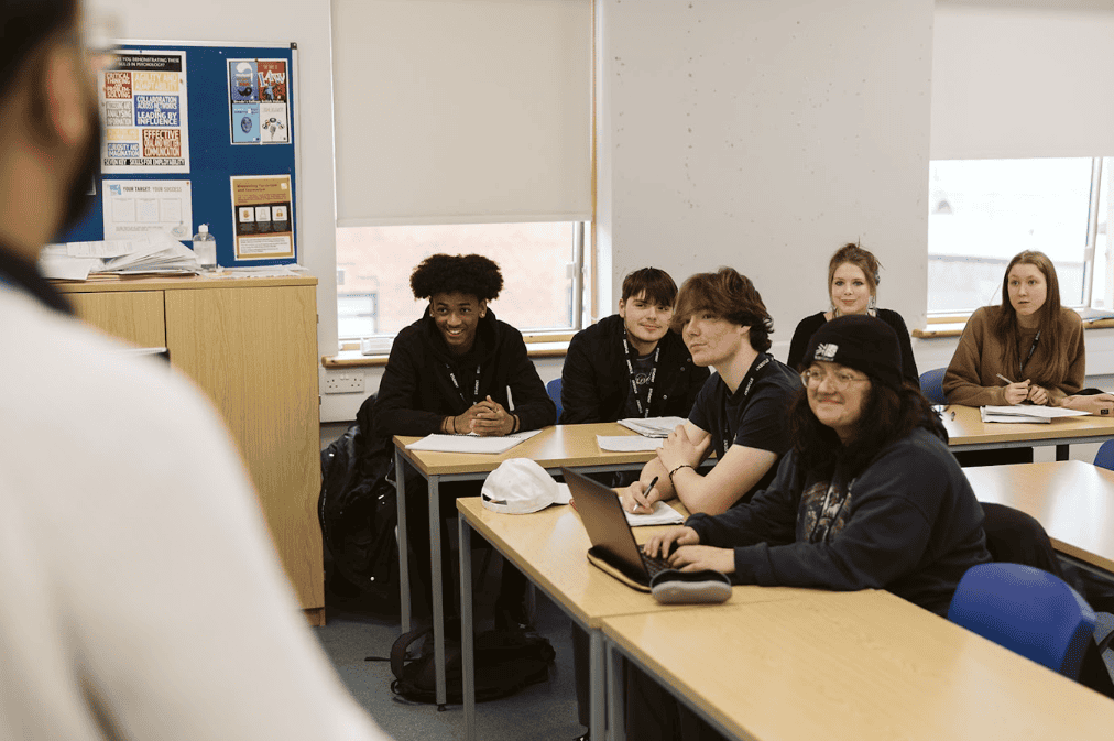 students sat in a classroom listening to a teacher