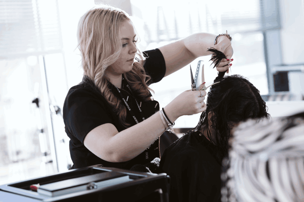 student cutting a clients hair