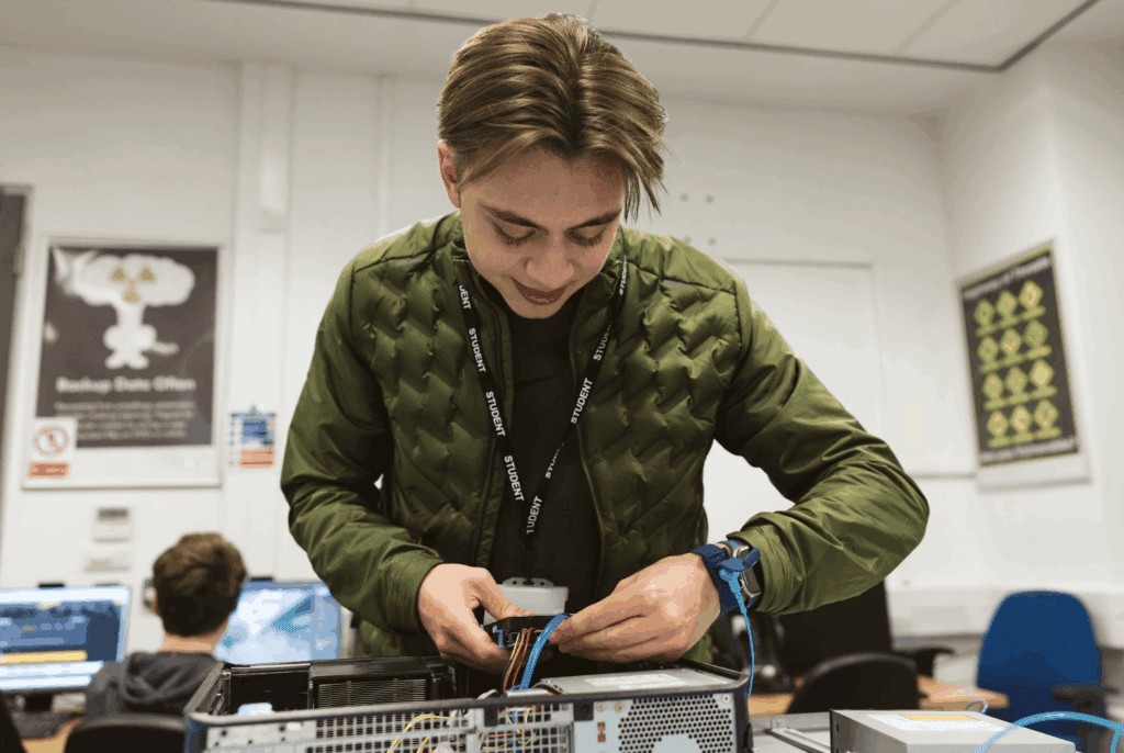 student fixing a monitor