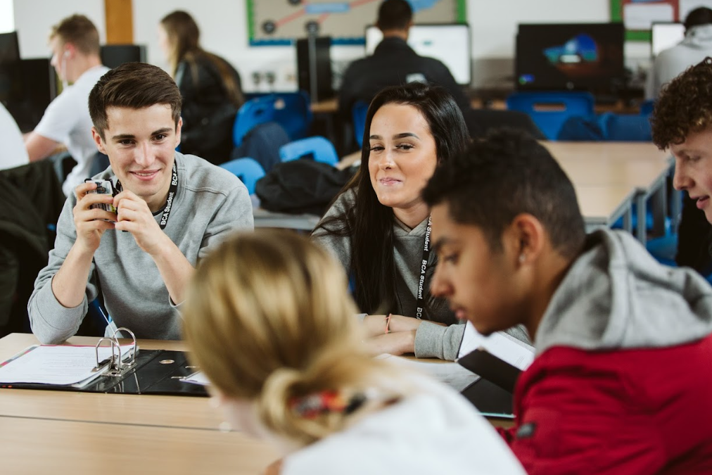 group of four students talking