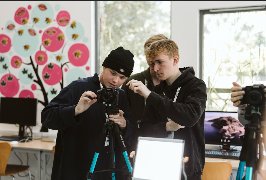 media students holding a camera