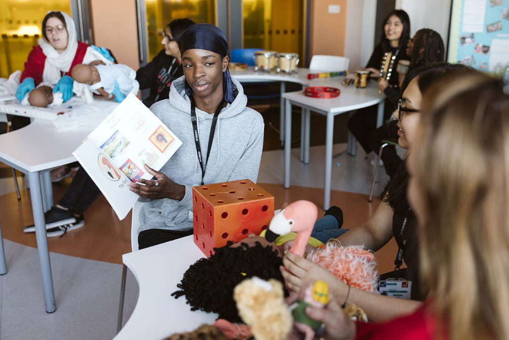 childcare students with children toys and books