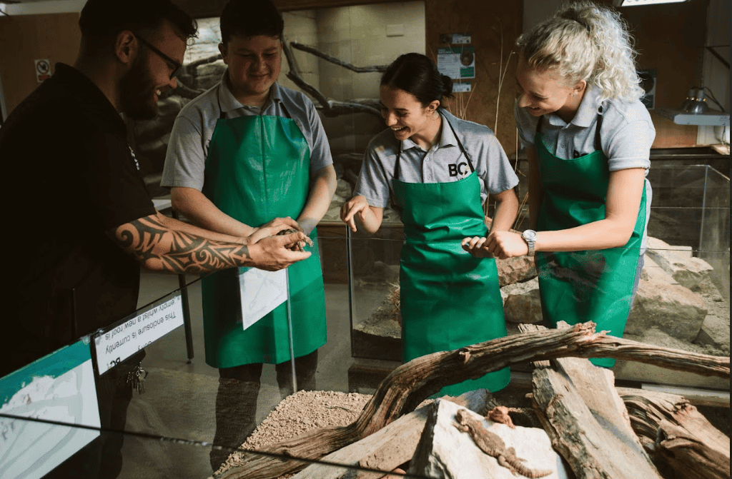students looking at animal in zoo