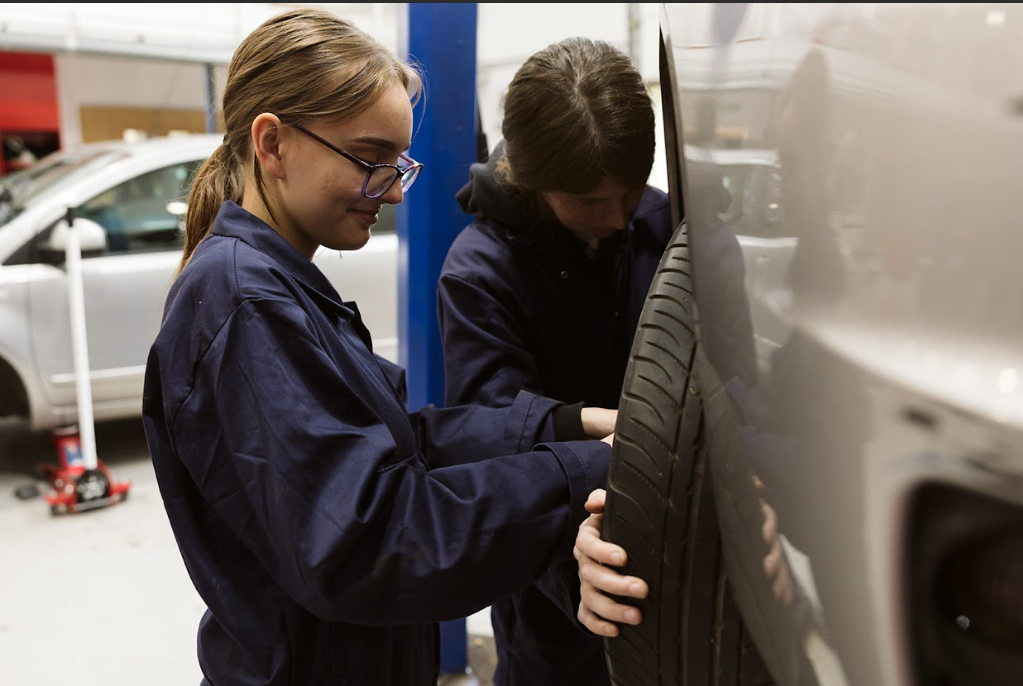 motor vehicle students fixing a tyre