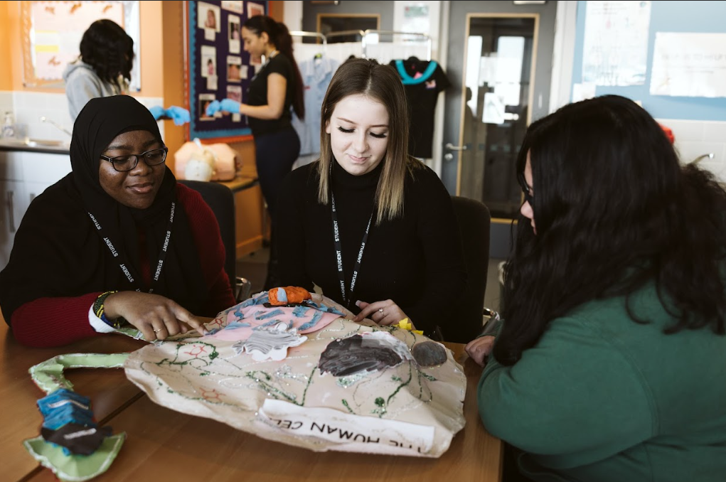 childcare students sat around with a teacher