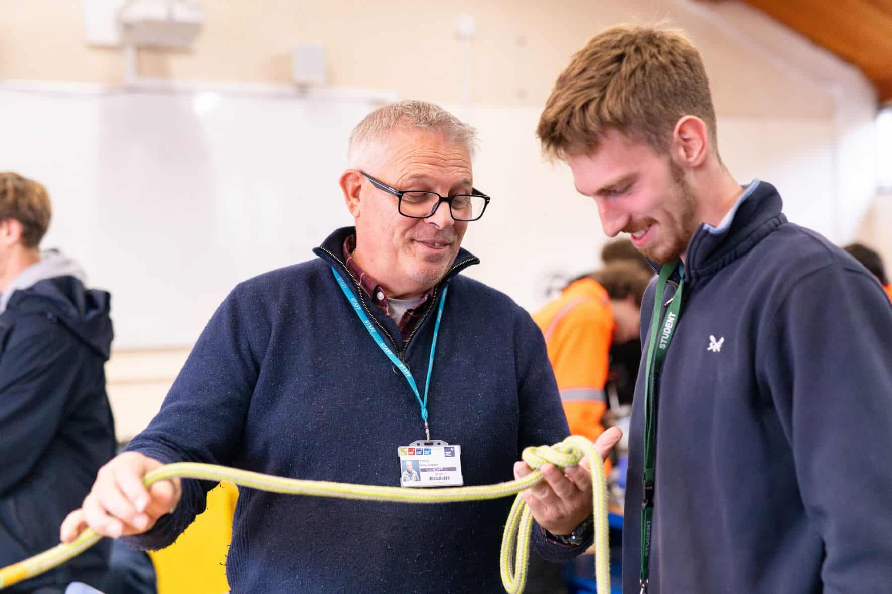 Teacher and student tying rope