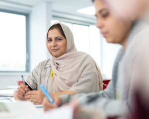 Adult students at a desk
