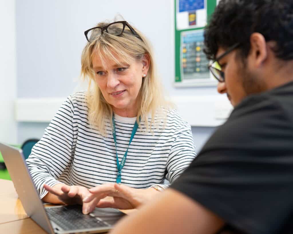 teacher supporting a student