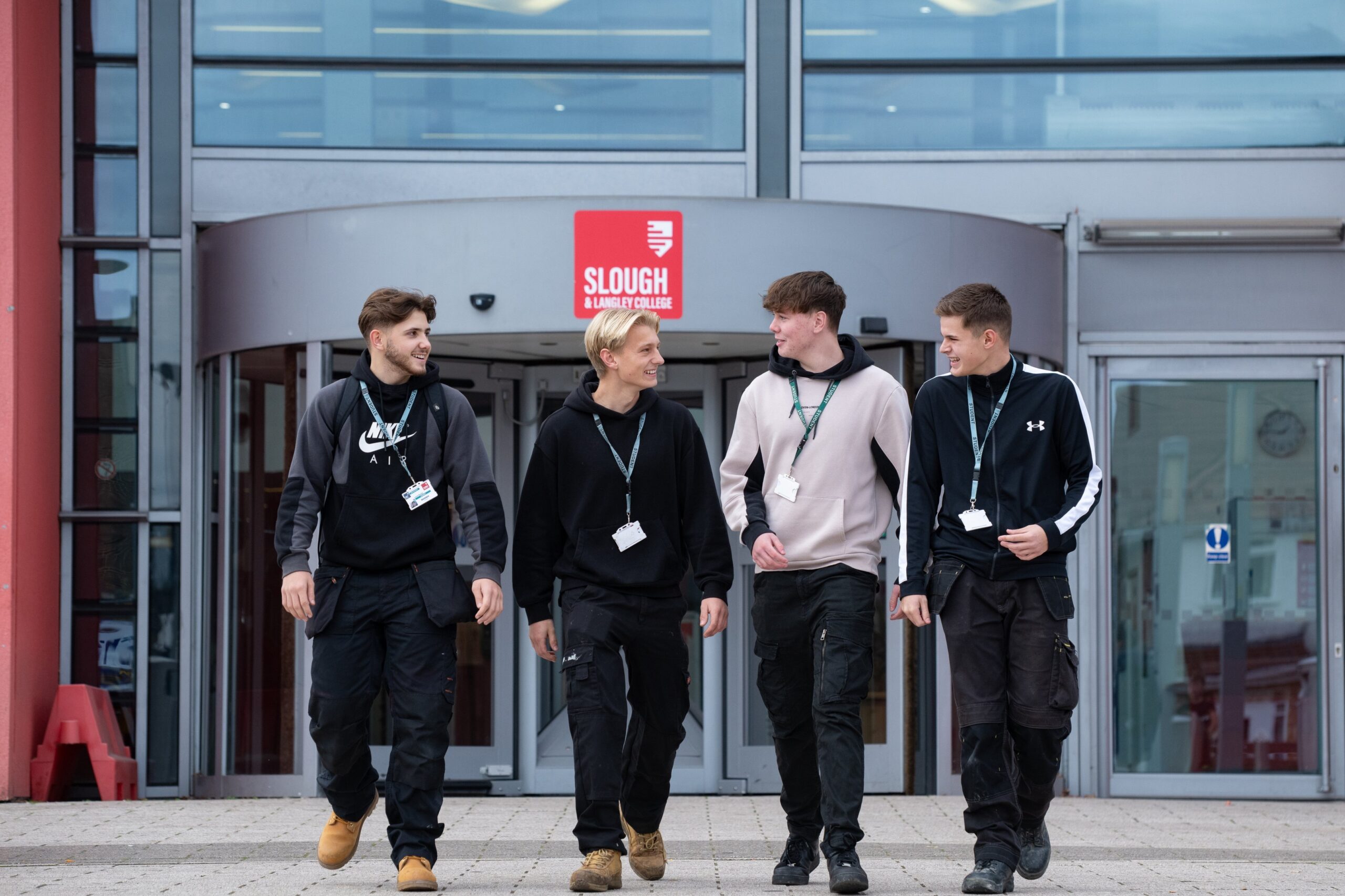 group of boys walking in front of S&L college
