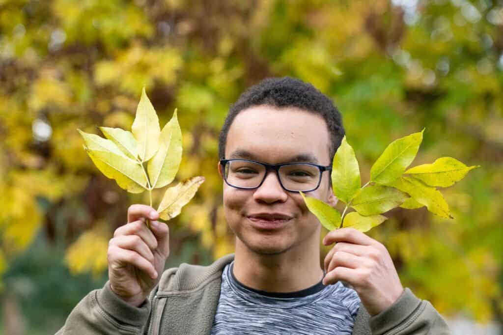 Alfie student holding leaves