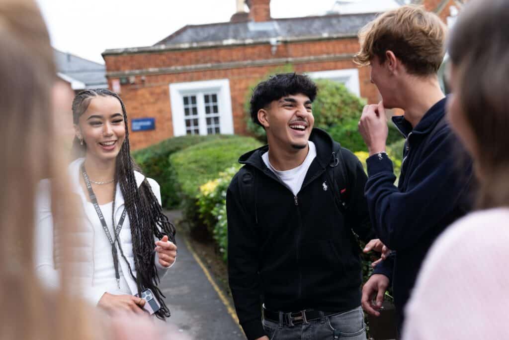 students outside college laughing